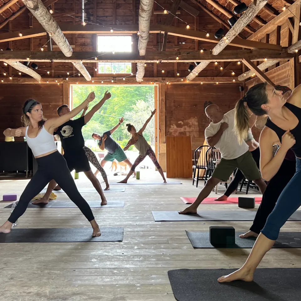 Triangle pose in a class in the barn