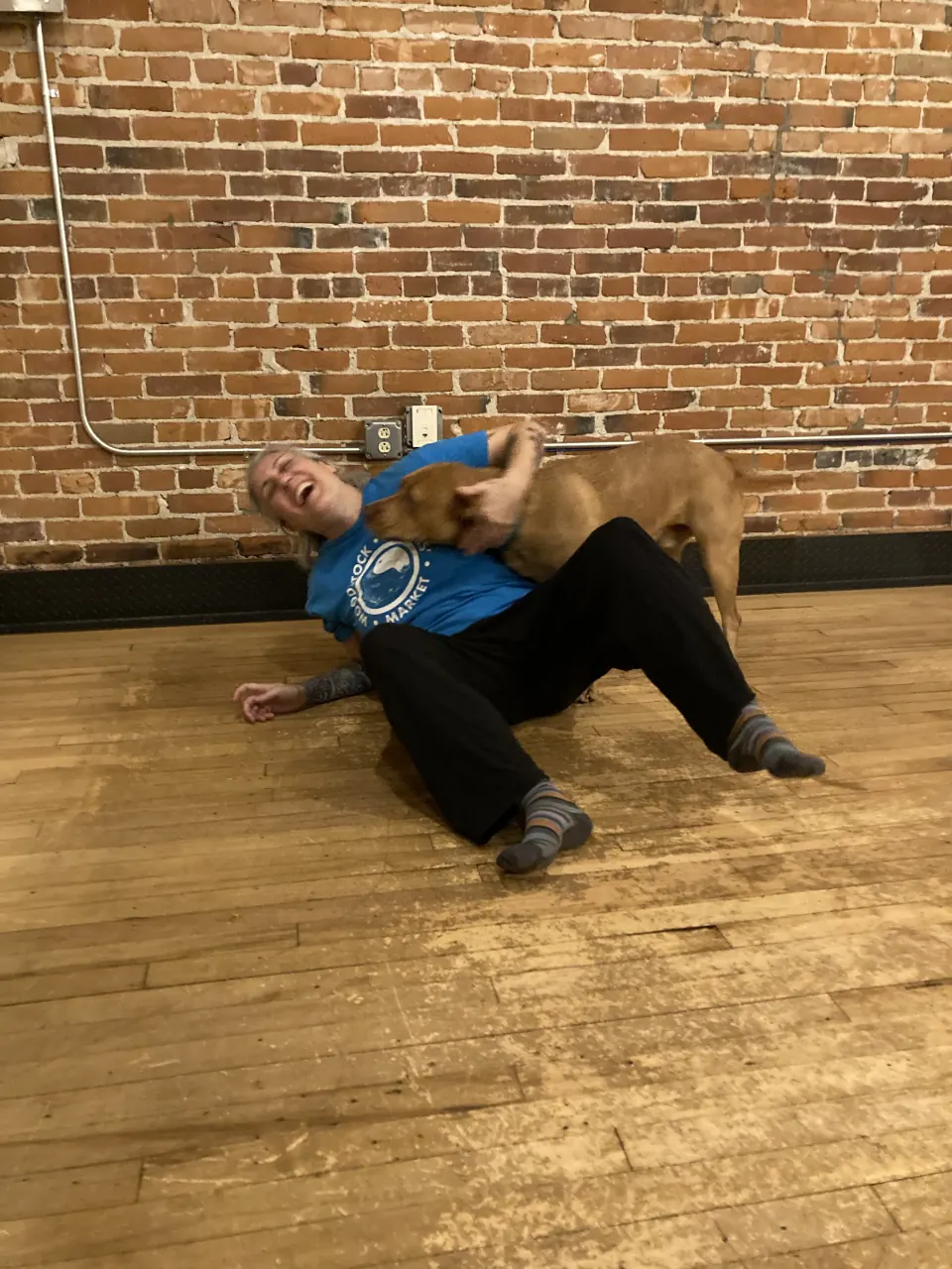 A member stretched out on the studio floor with Bean