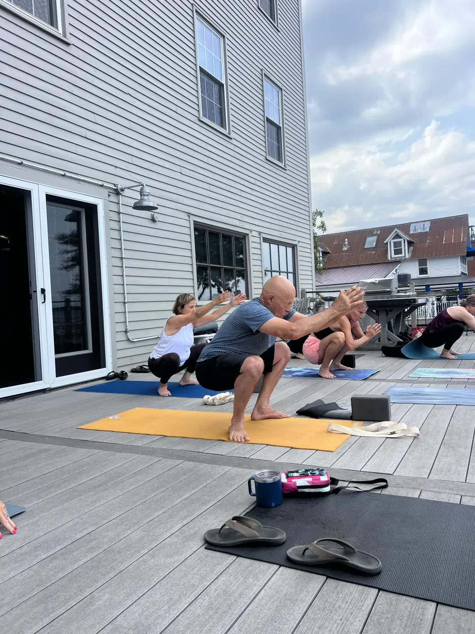 Chair pose in a class on a deck in Burlington