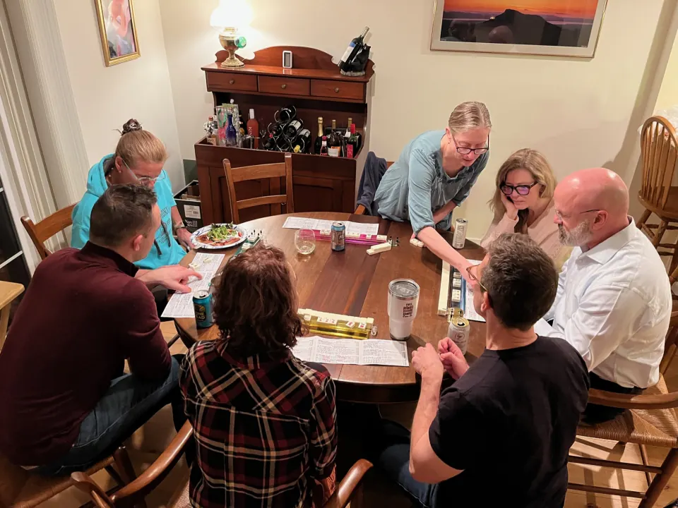 Members around a table playing mahjong