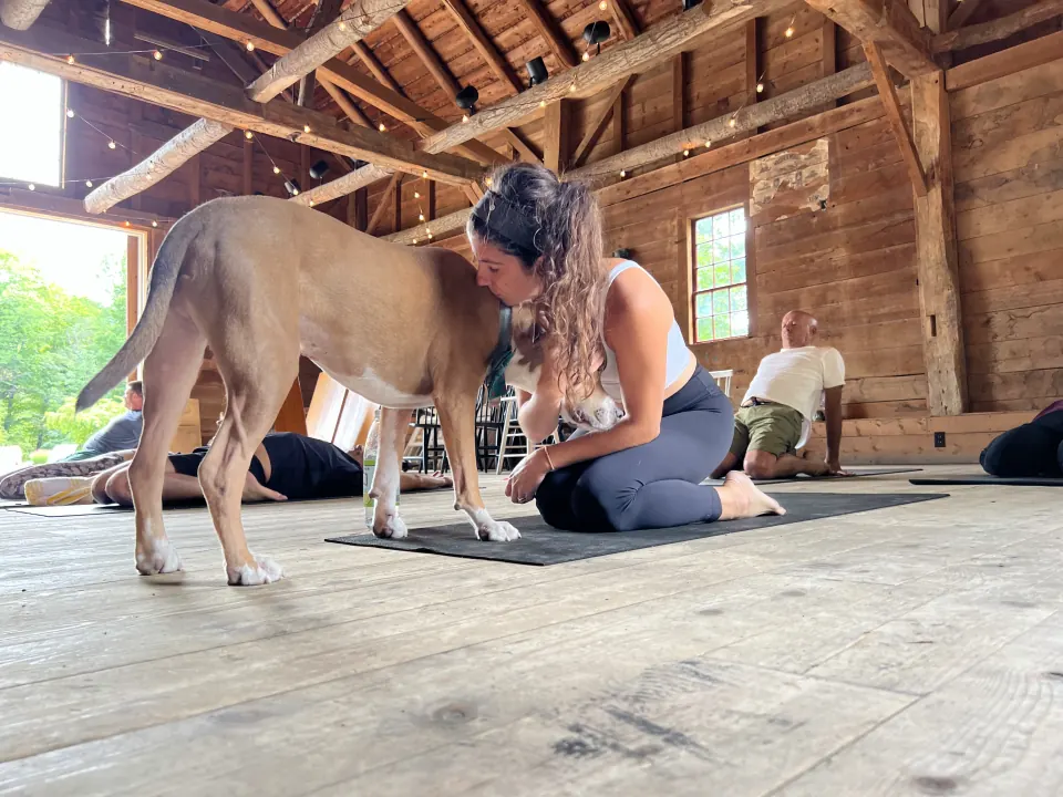 Ruth kneeling on her mat nose to nose with Hudson